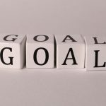 White letter blocks spelling 'Goal' on a neutral backdrop, ideal for business themes.